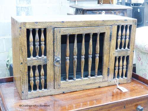 A 17th century style oak hanging food cupboard,with spindle ...