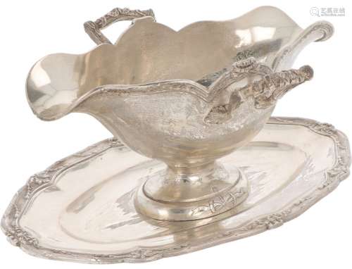 Sauce boat with silver saucer.