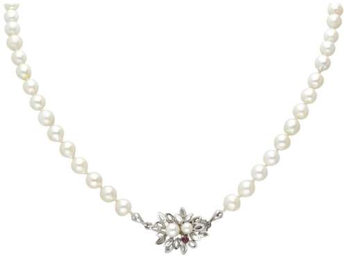 Single strand pearl necklace with a 14K. white gold closure ...