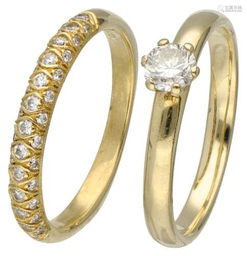 Set of a 14K. solitaire ring and an 18K. stacking ring, both...