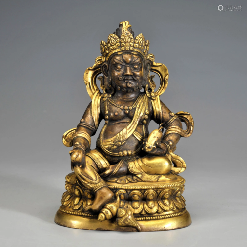 A Tibetan Gilt-bronze Seated Jambhala