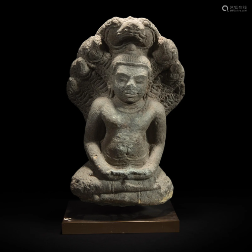 A Khmer style carved stone figure of Buddha seated