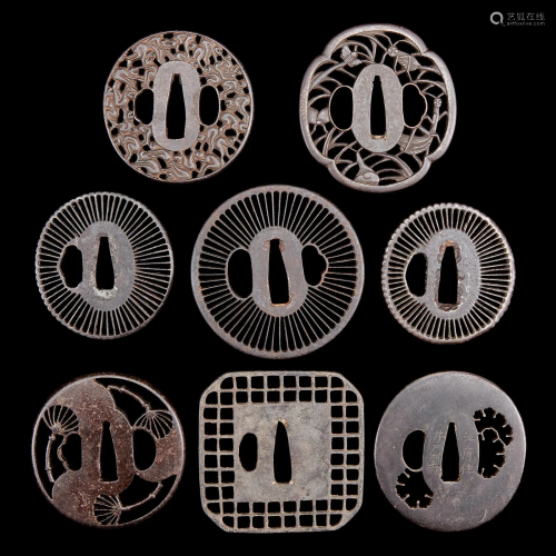 A group of eight Japanese pierced iron and metal tsuba