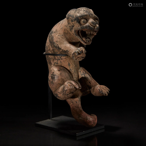 A carved and painted wood figure of a rampant feline