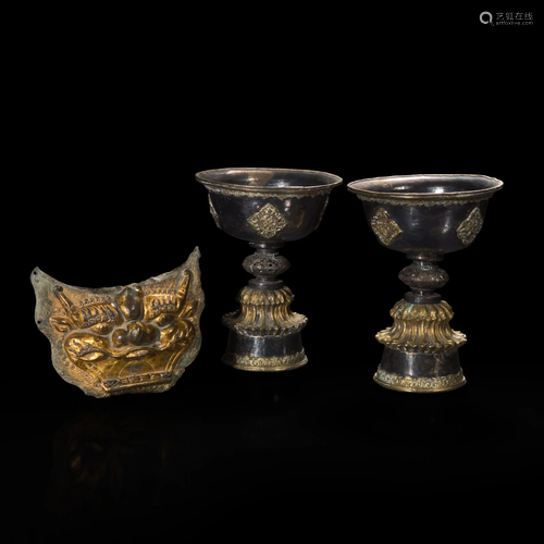 A pair of Tibetan or Mongolian parcel gilt butter lamps