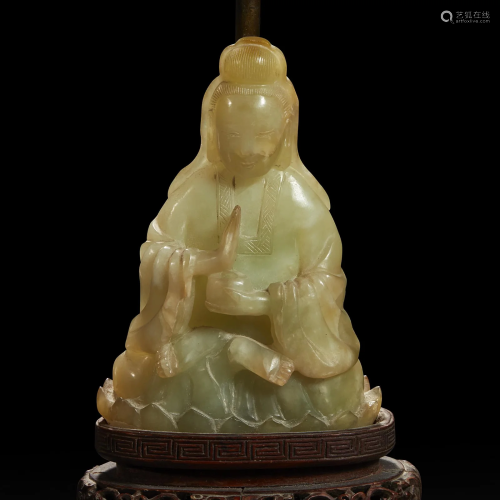 A Chinese carved mottled celadon jade figure of