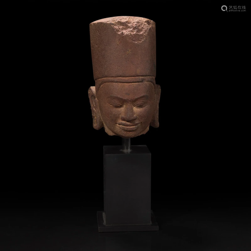 A carved red sandstone head of Vishnu in Khmer style