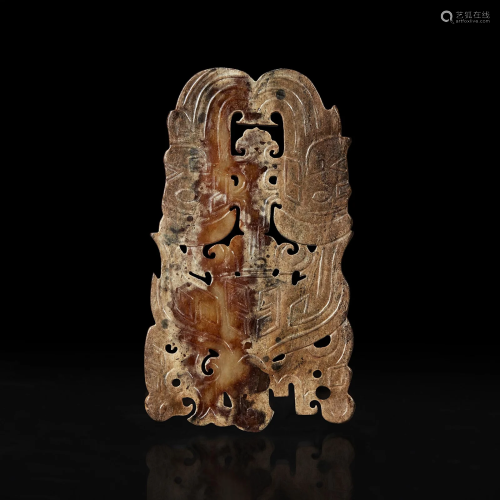 A Chinese archaistic carved beige and brown jade plaque