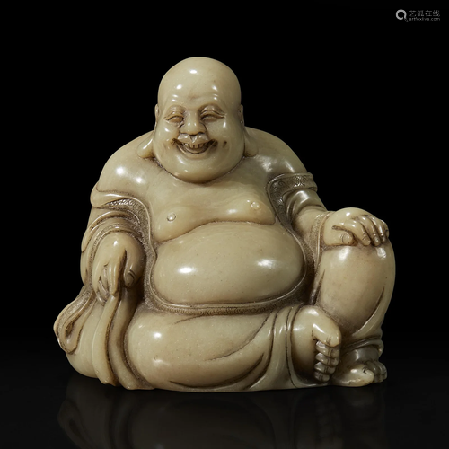 A Chinese carved soapstone figure of a seated Budai