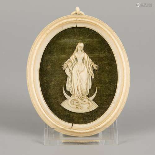 An ivory medallion with carved relief of a Madonna, Germany,...