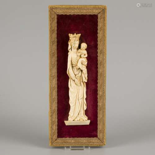 An ivory relief of a standing Madonna with lily mount on red...