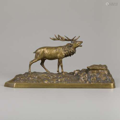 A bronze inkwell in the shape of a stag in a rocky landscape...