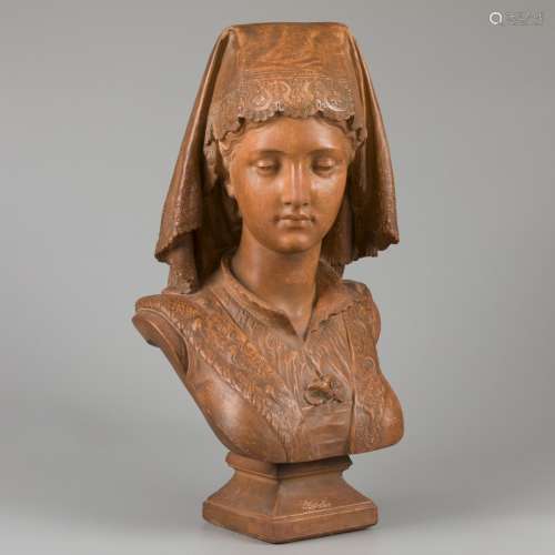 A terracotta buste of a young woman in French local dress.