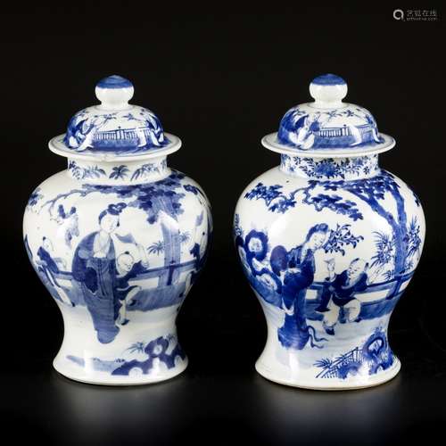 A set of (2) porcelain lidded vases with figurative decorati...