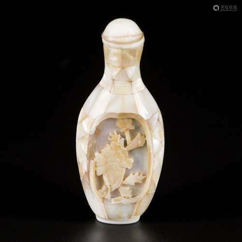 A mother-of- pearl snuff bottle with flower decoration, Chin...