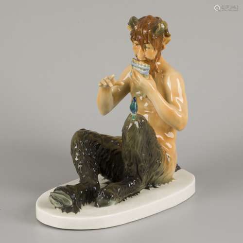 A polychromed porcelain statuette of a pan-flute playing fau...