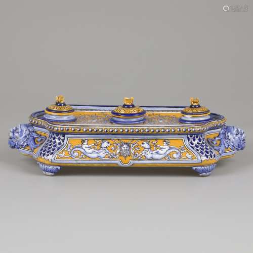 A majolica inkstand decorated with putti seated on sea monst...
