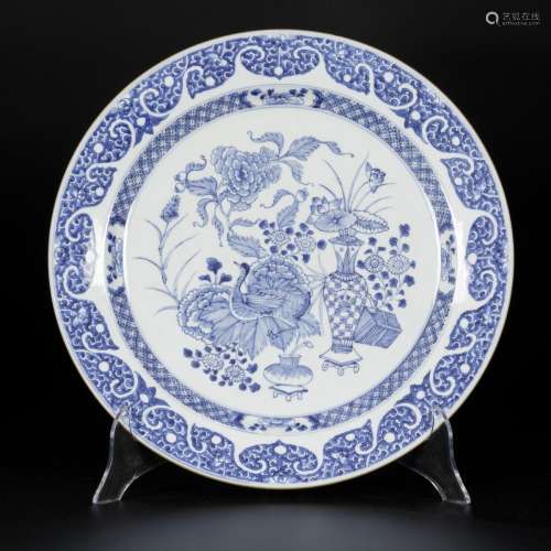 A porcelain charger with decoration of antiques and flowers,...