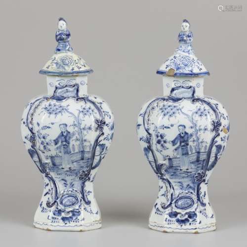 A set of (2) earthenware lidded vases with chinoiserie decor...