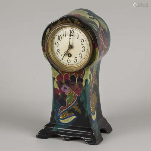 A ceramic mantel clock with floral decoration. Gouda, 1st ha...