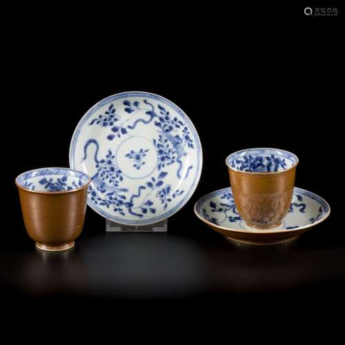 A set of (2) porcelain cups and saucers with floral decorati...