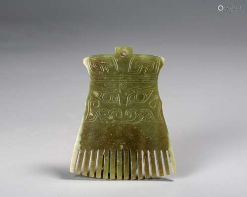 A Chinese Celadon Jade Toothed Animal Mask