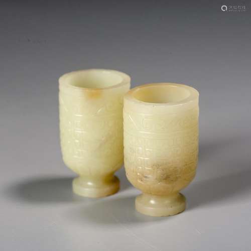 A Chinese Pair of Carved White Jade Cups, Ming Dynasty