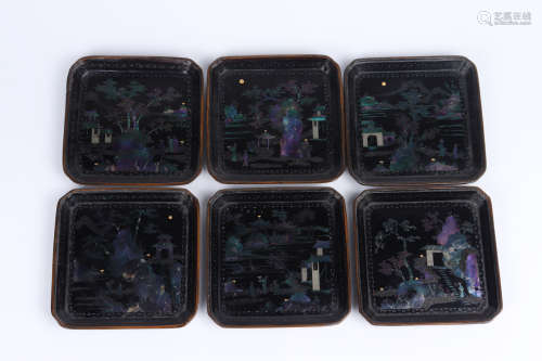 A set of small plates inlaid with lacquer