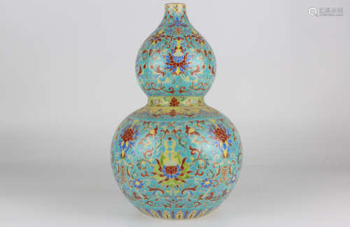 A QianLength famille-rose enamelled gourd vase with gilded f...