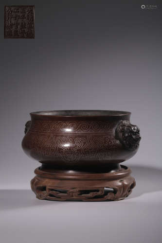 A bronze and silver filigree lion's ear stove