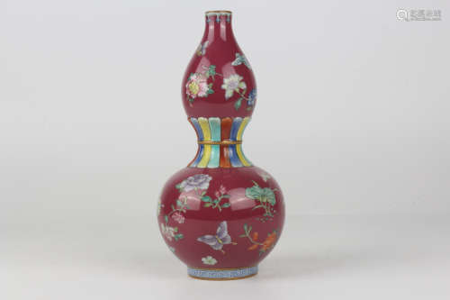 A QianLength enamelled carmine floral gourd vase