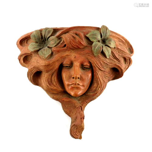 An Art Nouveau terracotta wall bracket,