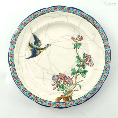 A Longwy art pottery plate, decorated in