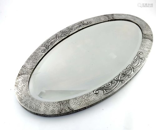 An Arts and Crafts pewter mirror, oval f