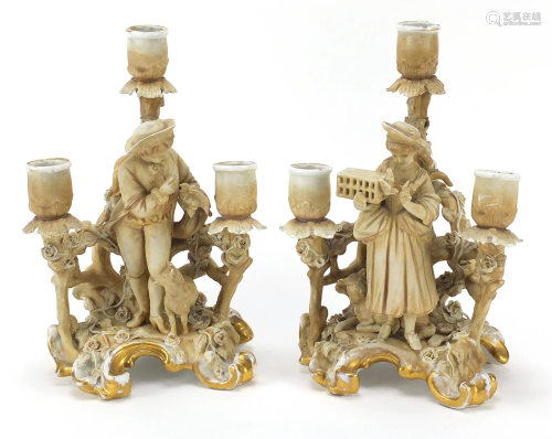 Pair of continental porcelain figural three branch