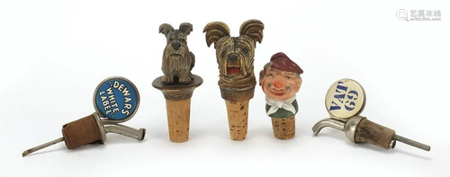 Five vintage bottle stops including carved Black Forest