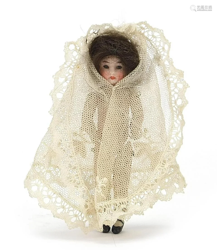 19th century bisque articulated doll wearing a white