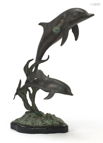 Bronze dolphin group raised on a shaped black slate