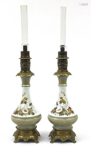 Pair of porcelain and brass mounted oil lamps having