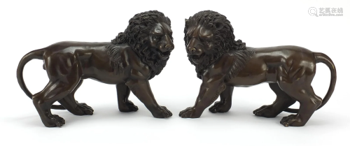 Pair of large patinated bronze standing lions, 30cm in