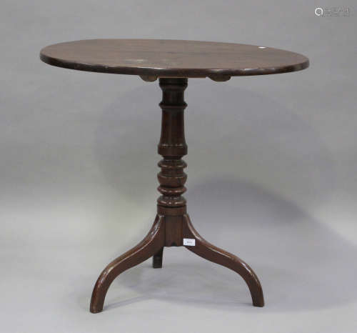 A 19th century mahogany tip-top wine table, raised on a turn...