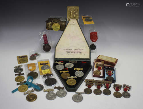 A collection of school attendance medals, including a group ...