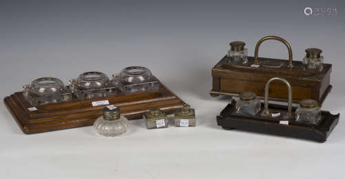 An Edwardian oak inkstand, fitted with three cut glass inkwe...