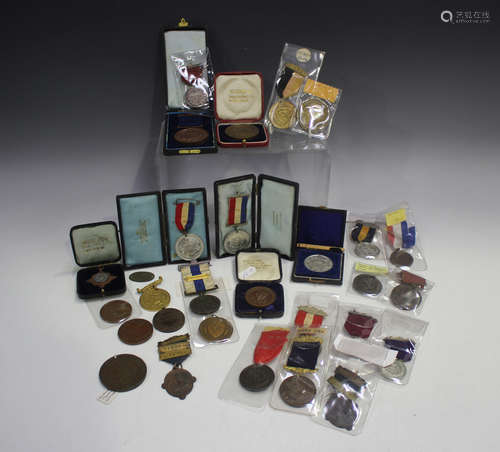 A collection of school attendance medals, including two Bris...