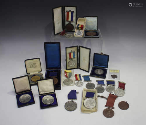 A collection of school attendance medals, including seven le...