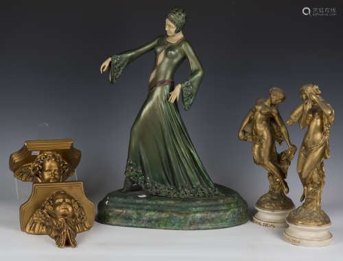 A pair of 20th century cast plaster and gilt painted figures...