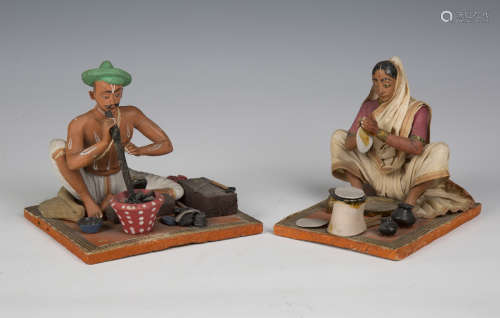 Two 20th century Indian clay figures of a seated man and wom...