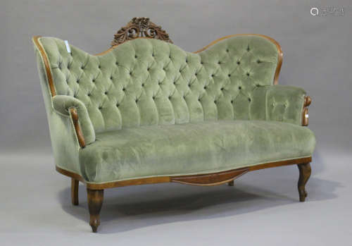 A Victorian mahogany showframe settee, upholstered in button...