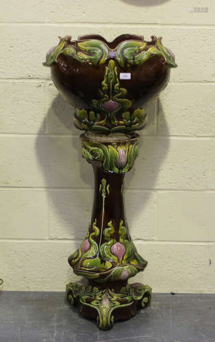 An Art Nouveau pottery jardinière and stand, height 111cm (f...