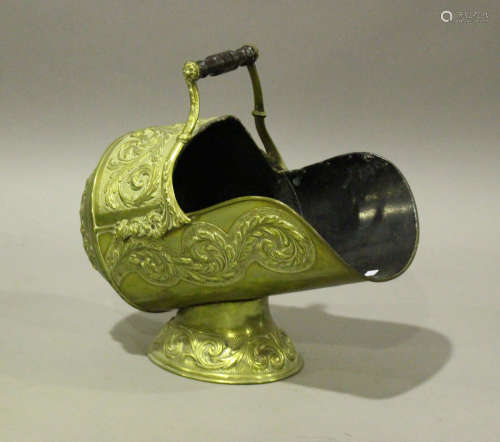 A Victorian brass helmet coal scuttle, embossed with foliate...